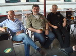 Toby Moody, Julian Ryder and Gordon Howell enjoy a beer in the sun