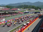 The grid with the Main grandstand and Ducati stand in the background