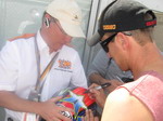 Colin signs a customer's helmet